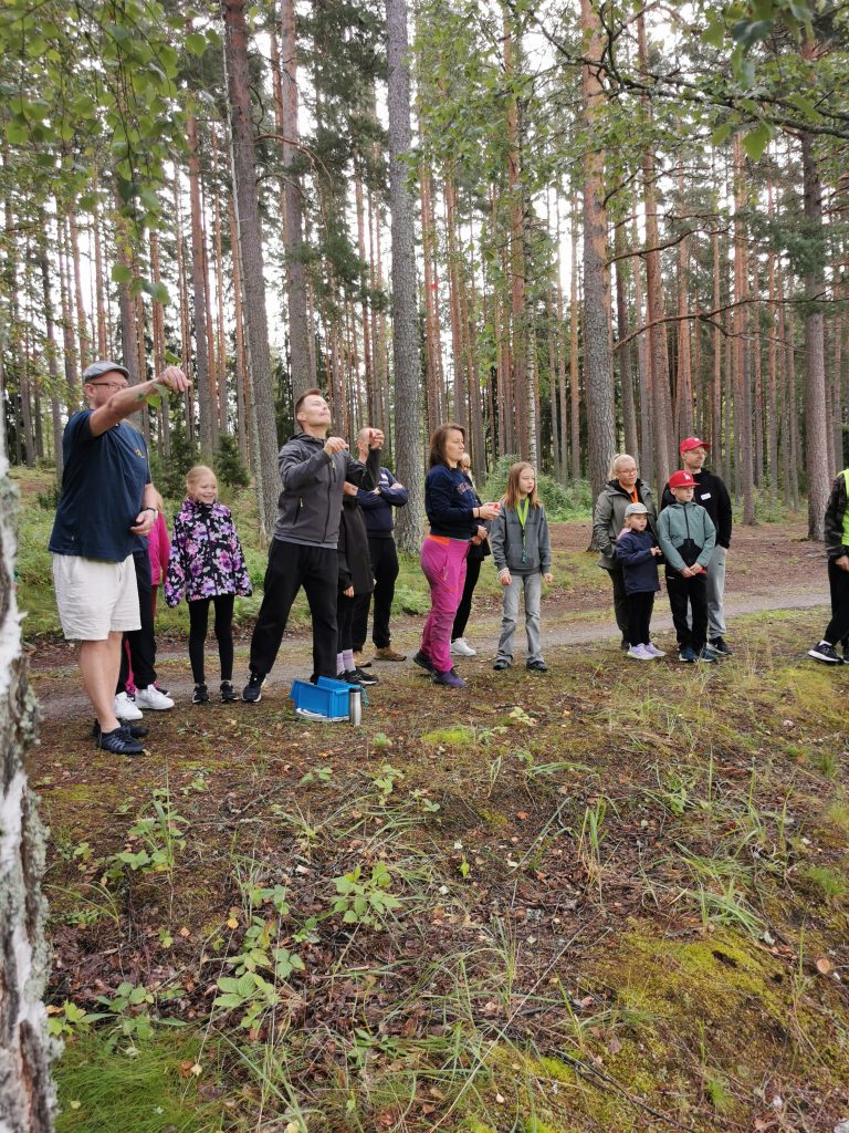 Rivi perheitä heittämässä tikkaa.