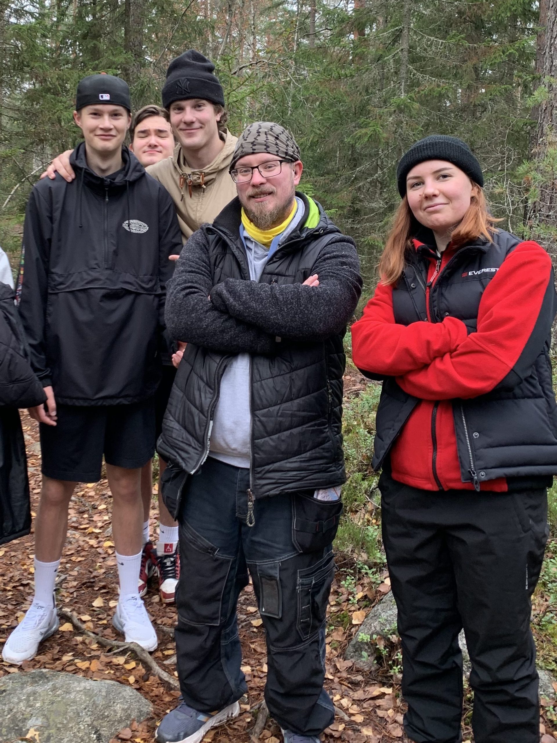 Oiva ja joukko muita nuoria ja ohjaajia poseeraa metsänhelmassa.